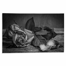 A Black And White Vintage Image Of A Rose On Wooden Table Rugs 59417810