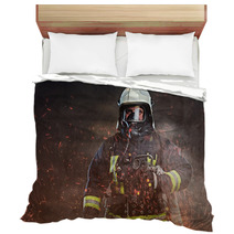 A Firefighter Dressed In A Uniform In A Studio Bedding 192482883