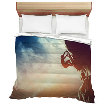 A Silhouette Of Man Climbing On Rock, Mountain At Sunset. Bedding 62334793