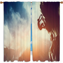 A Silhouette Of Man Climbing On Rock, Mountain At Sunset. Window Curtains 62334793