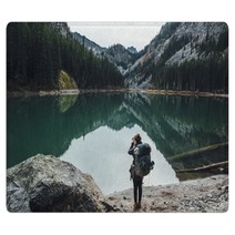 Backpacker Taking Picture Of Teal Lake Rugs 174363687