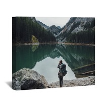 Backpacker Taking Picture Of Teal Lake Wall Art 174363687