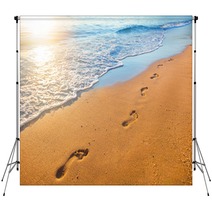 Beach Wave And Footprints At Sunset Time Backdrops 112702409