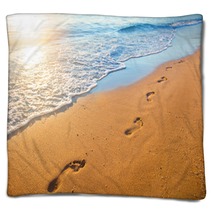 Beach Wave And Footprints At Sunset Time Blankets 112702409