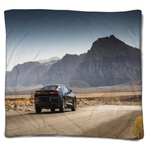 Black Sports Car On A Desert Road Blankets 144227904