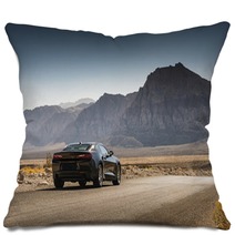 Black Sports Car On A Desert Road Pillows 144227904
