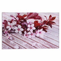 Blooming Tree Branch With Pink Flowers On Wooden Background Rugs 64124462