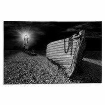 Boat On Beach Lit By The Beam Of Lighthouse Rugs 43176490