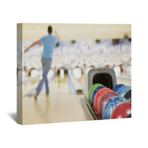 Bowling Ball Machine With Man Bowling In The Background Wall Art 8093154