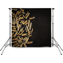 Bullets From The Gun Placed On A Black Wooden Table Backdrops 130223035