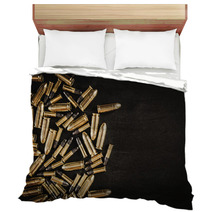 Bullets From The Gun Placed On A Black Wooden Table Bedding 130223035