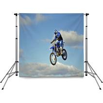 Flight Of Biker Motocross Against The Blue Sky And Clouds Backdrops 46705772