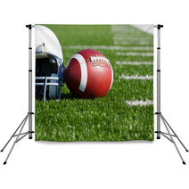 Football And Helmet On The Field Backdrops 42014628