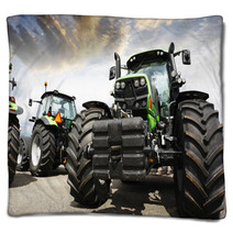 Giant Tractors Set Against A Sunset Sky And Clouds Blankets 67295763