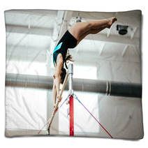 Girl Athlete Gymnast Exercises On Uneven Bars Blankets 136677938