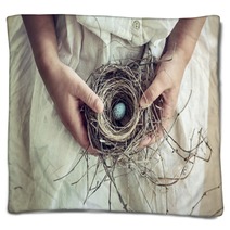 Girl Holding Blue Speckled Egg In Bird Nest On Lap Blankets 64772362