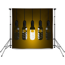 Glowing Spiral Light Bulb Hanging Among Dead Ones Backdrops 67587014