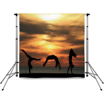 Group Of Gymnasts Tumbling In Sunset Backdrops 48042586