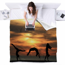 Group Of Gymnasts Tumbling In Sunset Blankets 48042586