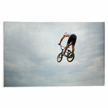 Guy Jumps On Bike Rugs 55251710