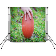 Hand On Rugby Ball On Green Grass Background Backdrops 60202151
