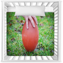 Hand On Rugby Ball On Green Grass Background Nursery Decor 60202151