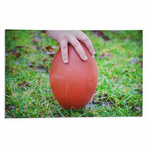 Hand On Rugby Ball On Green Grass Background Rugs 60202151