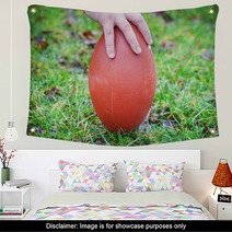 Hand On Rugby Ball On Green Grass Background Wall Art 60202151