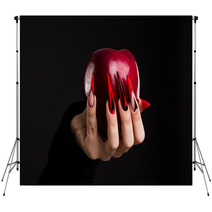 Hands With Scary Nails Manicure Holding Poisoned Red Apple Isolated On Black Background Backdrops 135127741