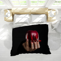 Hands With Scary Nails Manicure Holding Poisoned Red Apple Isolated On Black Background Bedding 135127741
