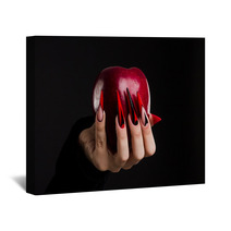 Hands With Scary Nails Manicure Holding Poisoned Red Apple Isolated On Black Background Wall Art 135127741