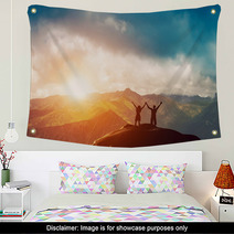 Happy Couple Together On The Peak Of A Mountain At Sunset Wall Art 62334764