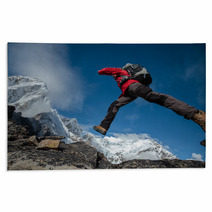 Hiker Jumps Over Rocks In Himalaya Mountains Rugs 64747093
