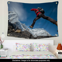 Hiker Jumps Over Rocks In Himalaya Mountains Wall Art 64747093
