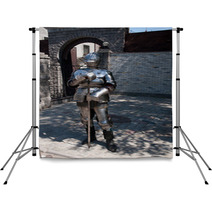 Knight In The Ancient Metal Armor Standing Near The Stone Wall Backdrops 66227995