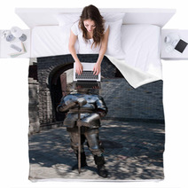 Knight In The Ancient Metal Armor Standing Near The Stone Wall Blankets 66227995