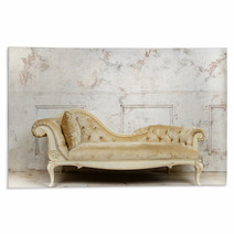 Luxurious Golden Sofa On A Background Of Old White Wall Rugs 136055200