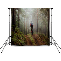 Male Athlete Mountainbiker Rides A Bicycle Along A Forest Trail In Forest Mist Mysterious View Backdrops 117998340