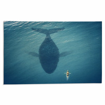 Man In A Boat Floats Next To A Big Fish Whale Rugs 49510969