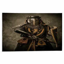 Medieval Knight With Sword And Shield Against Stone Wall Rugs 48836912