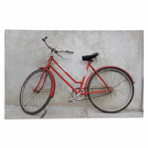 Old Red Bicycle Leaning Against A Wall Rugs 2345232