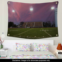 Pans Of A High School Football Stadium In Front Of A Beautiful Pink And Purple Sky Wall Art 137099092