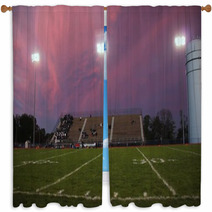 Pans Of A High School Football Stadium In Front Of A Beautiful Pink And Purple Sky Window Curtains 137099092
