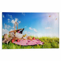 Picnic Basket With Bread And Wine On Meadow Rugs 191690367