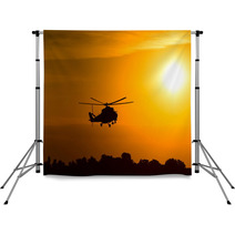 Silhouette Of Military Helicopter At Sunset Backdrops 85565041