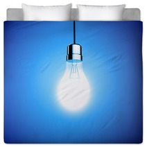 Single Lightbulb Shining A Bright Light On Blue Background Bedding 65162695
