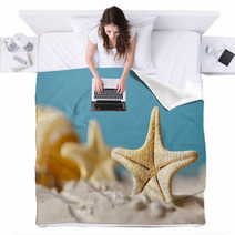 Starfish On Sand And Blue Background Blankets 64985103