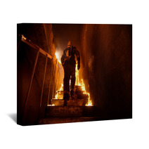 Strong And Brave Firefighter Going Up The Stairs In Burning Building Stairs Burn With Open Flames Wall Art 164563720