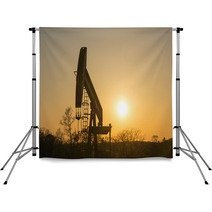 Texas Oil Well Against Setting Sun Backdrops 61657158
