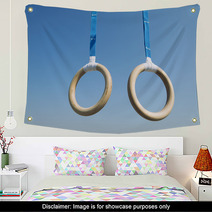 Traditional Wooden Gymnast Rings Hanging From Blue Straps In Clear Blue Sky Wall Art 93445411